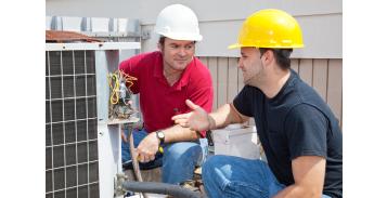 image of a heater repair persons installing an air conditioning system