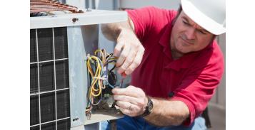 image of an air conditioning repair person fixing an AC unit