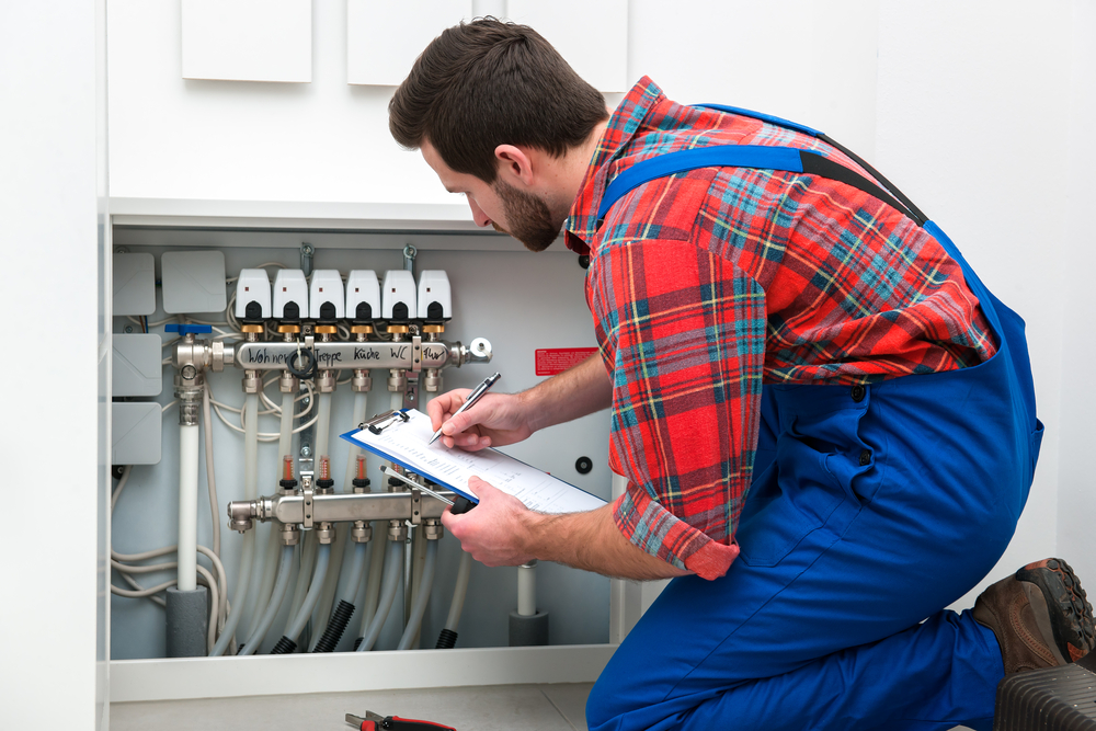 image of a heater repair person installing a heating system