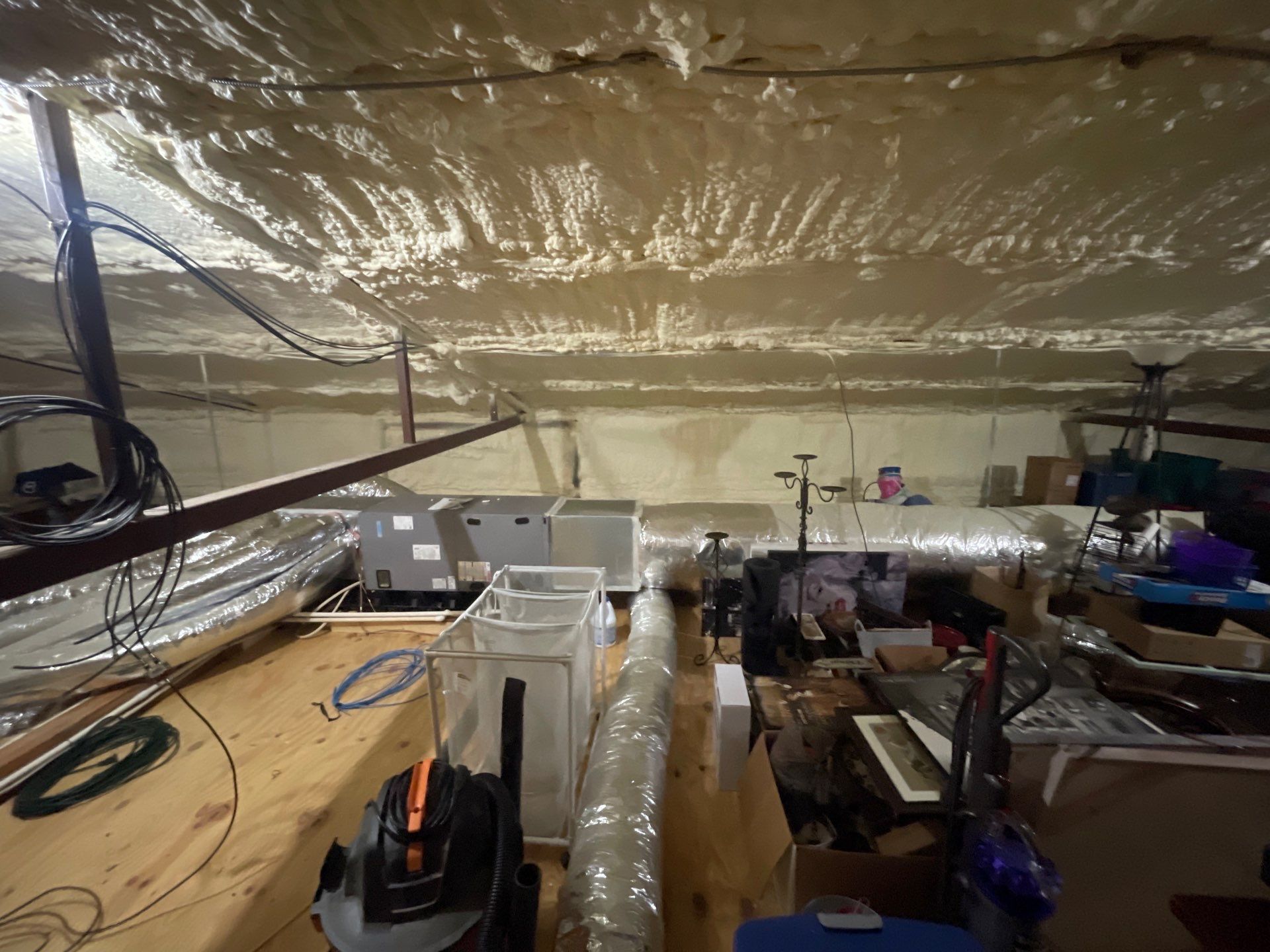 image of two AC repair men fixing an air conditioner