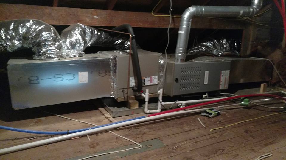 A duct blower in an attic.